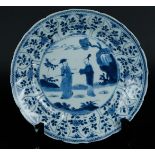 A porcelain plate with tulip-shaped beds, outer rim with floral decor, the center with dignitary and