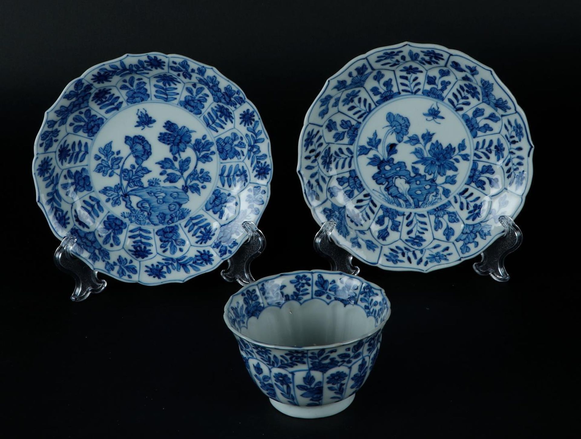 Two porcelain plates and bowl with lotus leaf shaped outer beds in relief with floral decor, center 