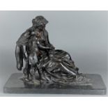 A dark patinated, classic bronze statue depicting mother and child.