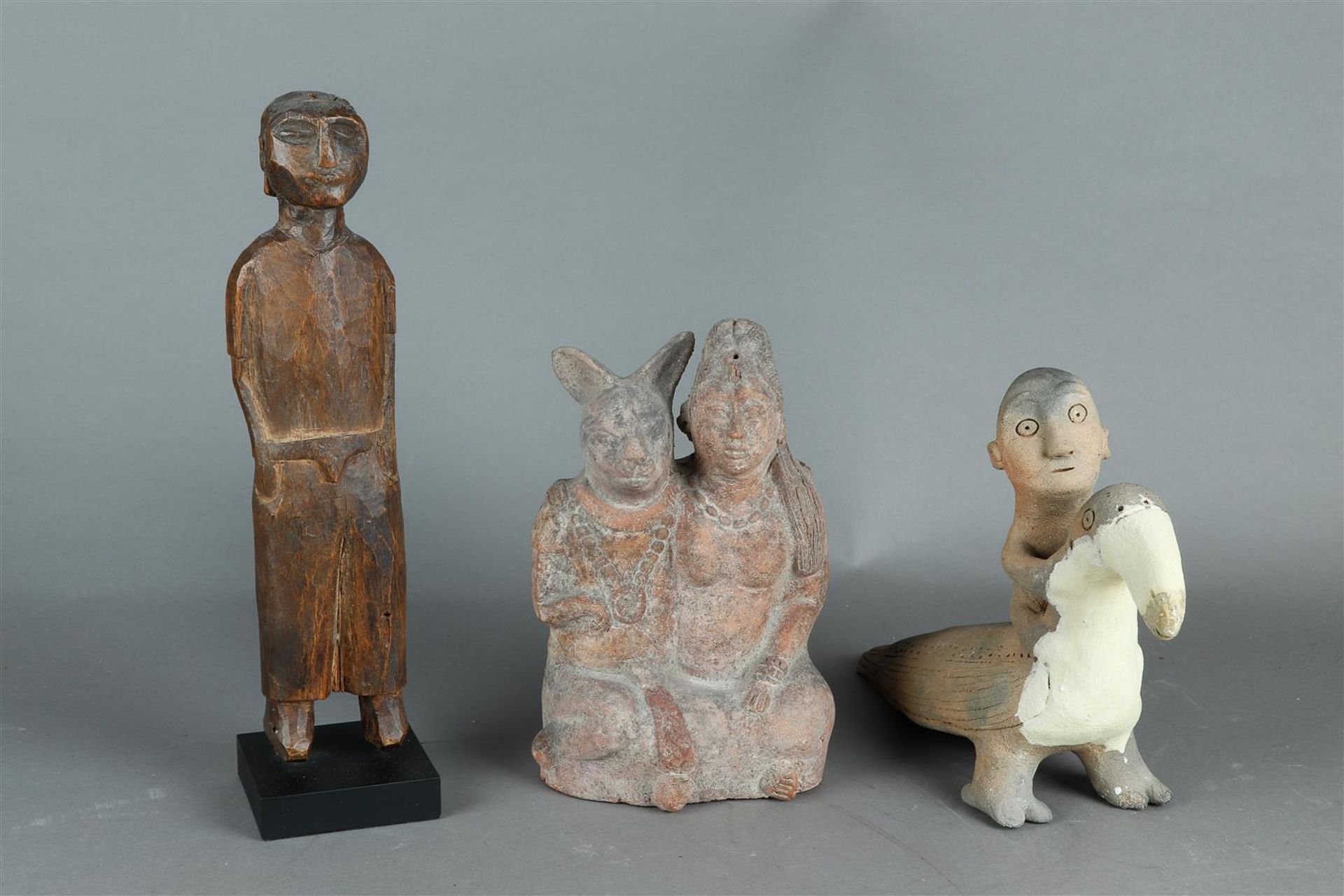 A lot consisting of (2) terracotta groups. A woman with a hare, and a bird rider. Possibly India and