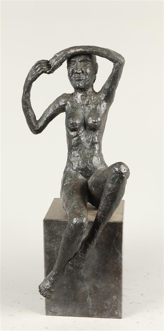 A bronze sculpture of a seated naked lady, on a marble bust. 2nd half of the 20th century.
