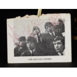 A page from a program booklet with the signatures of the Rolling Stones and "To DJ" (referring to Da