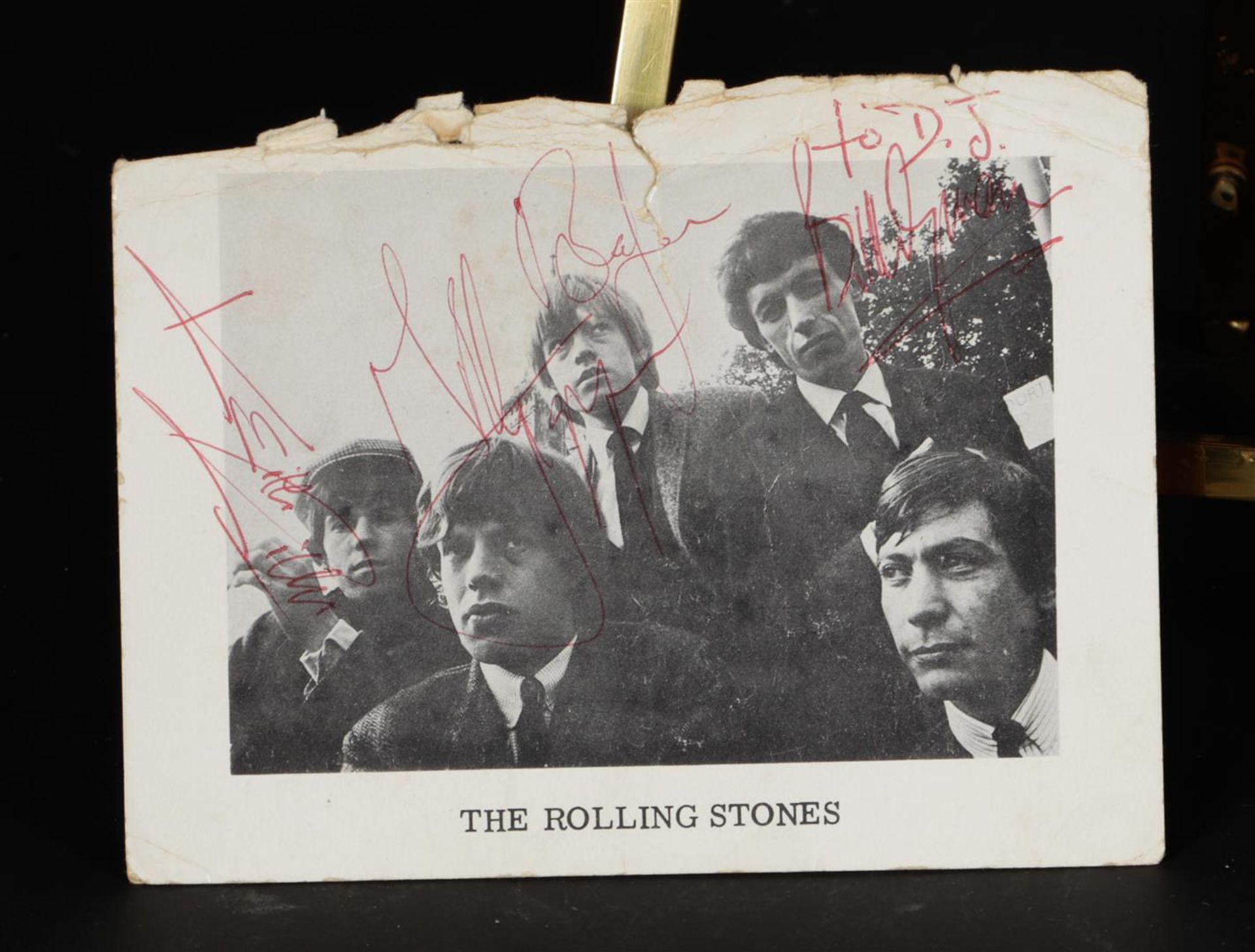 A page from a program booklet with the signatures of the Rolling Stones and "To DJ" (referring to Da