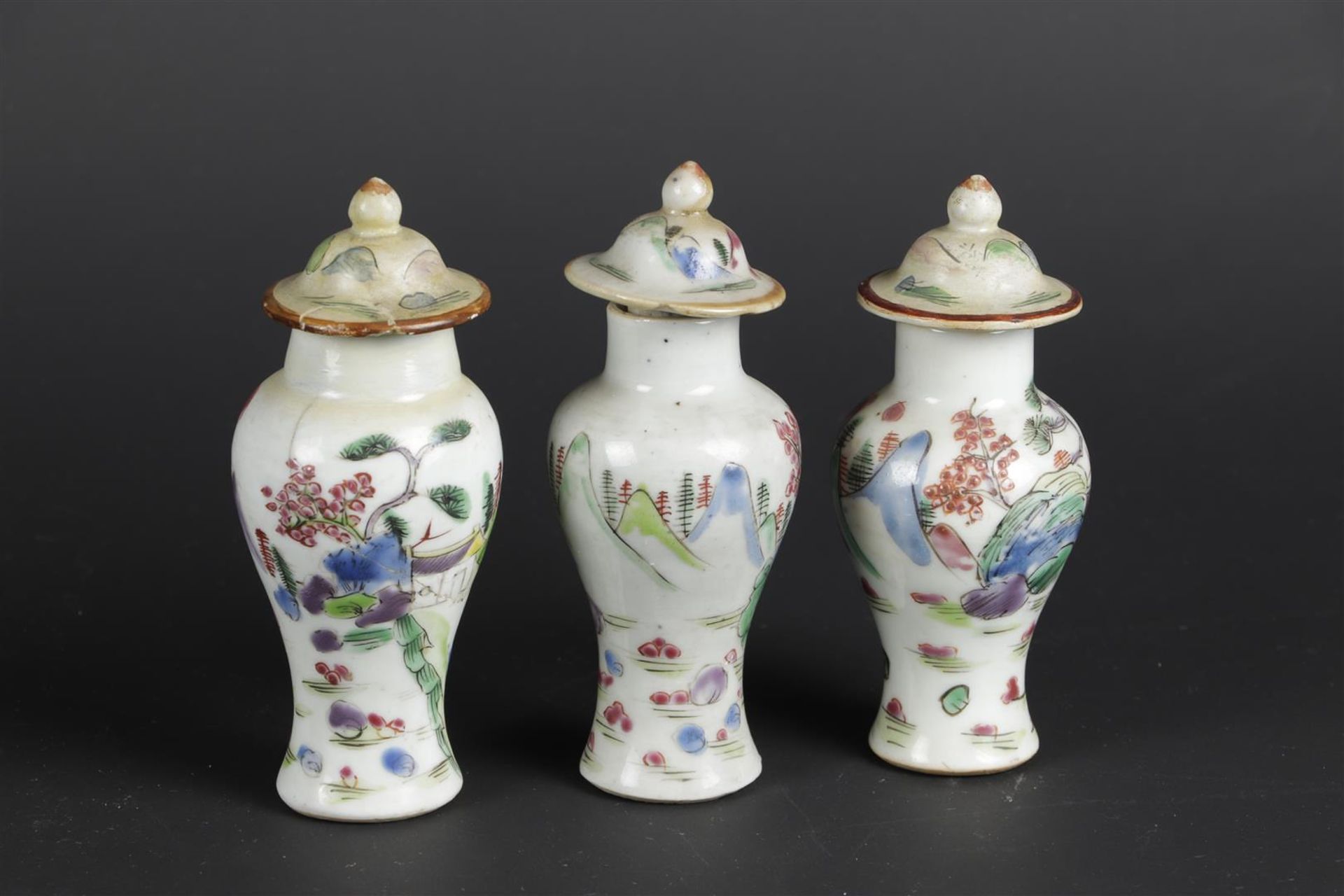 Three porcelain Famille Rose lidded jars with mountain landscape decoration. China, Qianlong.
