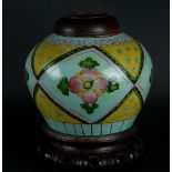 A porcelain storage jar with wooden lid and base. China, 19th century.