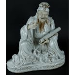 A porcelain blanc de chine sage with scroll drawing in hand, hands and face are unglazed. China, 19/