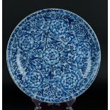 A porcelain dish with large peony decoration between floral decoration. China, Kangxi.