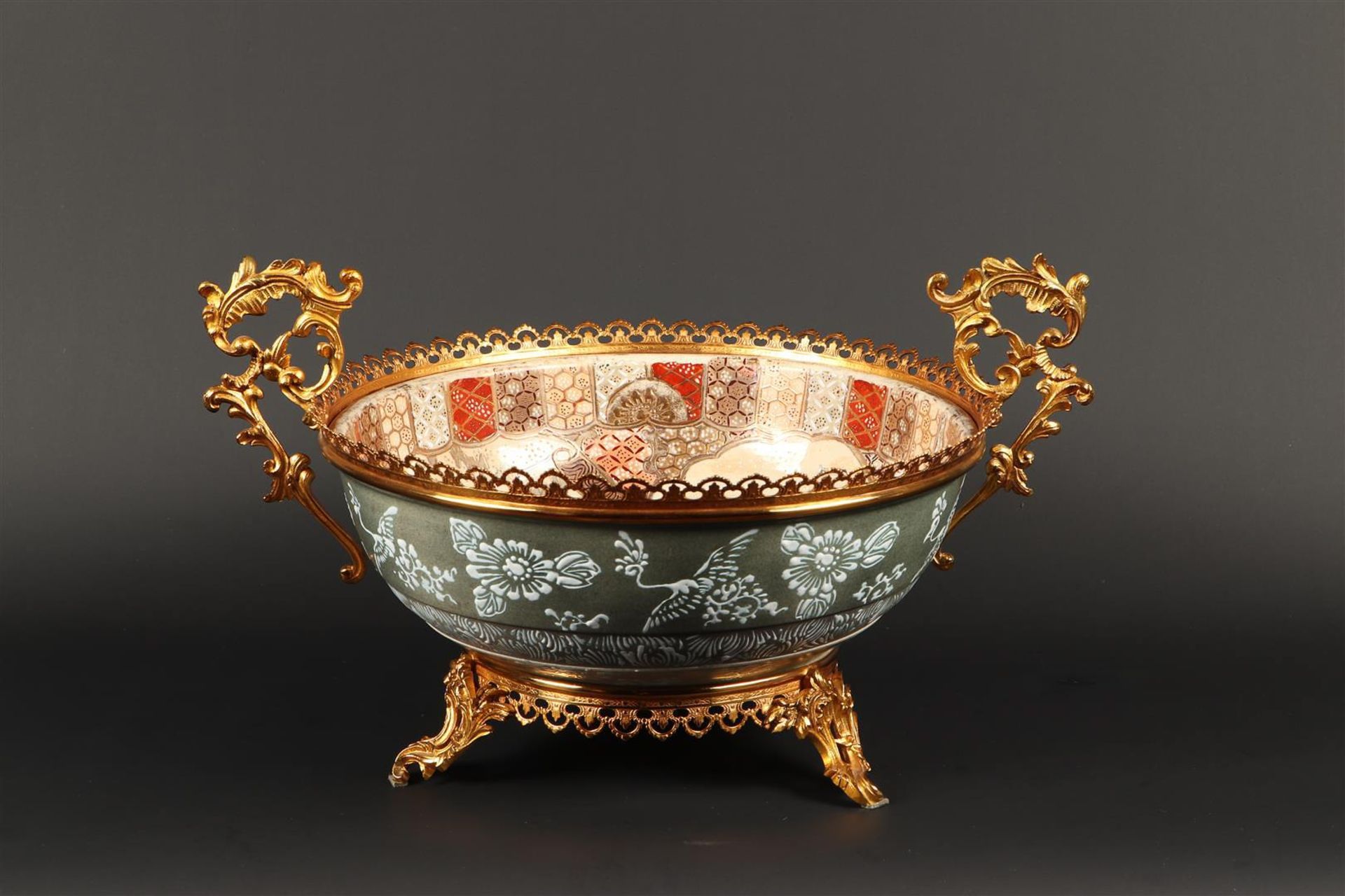 A Satsuma earthenware bowl in brass frame, inside decorated with various figures. Japan, 1st half 20