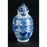 A porcelain lidded vase with sloping compartments with floral decor. China, Kangxi.