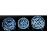 Three various porcelain plates with ribbed decoration, with a stylized lotus flower in the center. M