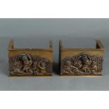 A set of cast brass fireplace ornaments with putti in a river.