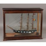 A ship model of a 19th century frigate, in display case. 20th century.