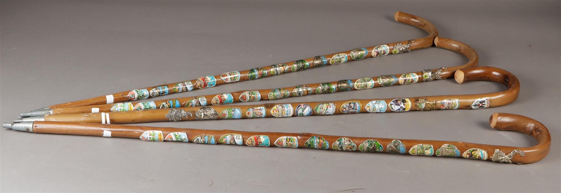 And lot with (4) German walking sticks with coats of arms. Ca. 1950.