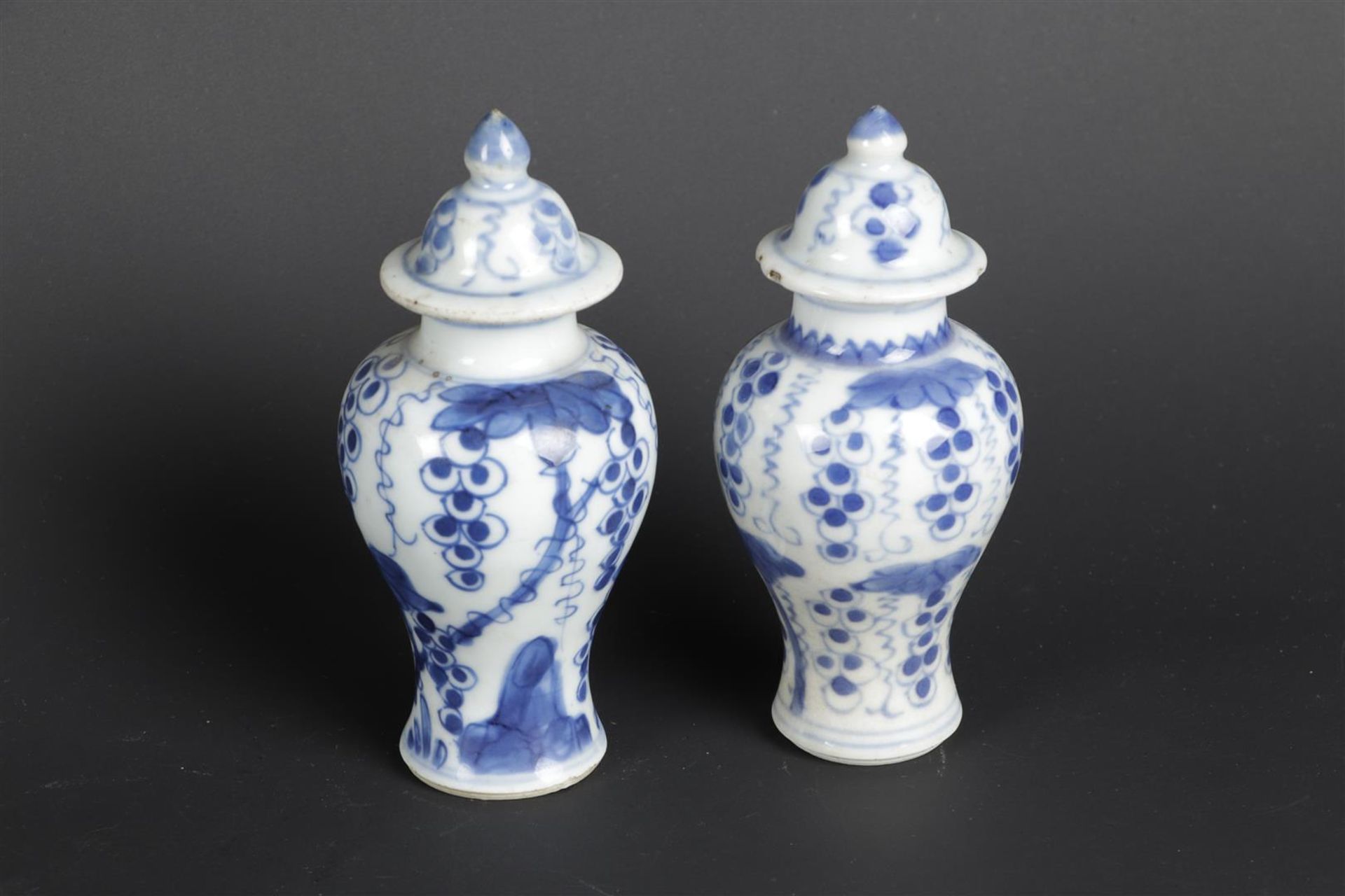 Two porcelain lidded vases with a so-called grape-on-vine decor. China, Qianlong.