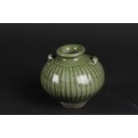 A stoneware Celadon ribbed vase with two ears. China, 19th century.