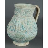 A Persian turquoise ewer with calligraphic relief design, Kashan, 13/14th C.