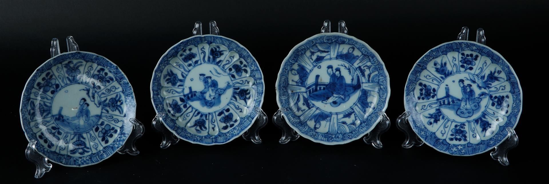 Four porcelain plates with decoration in the center of two seated figures in a landscape. China, Kan