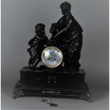 A capital mantel clock with a clock image depicting a mother with child. The timepiece in a marble c