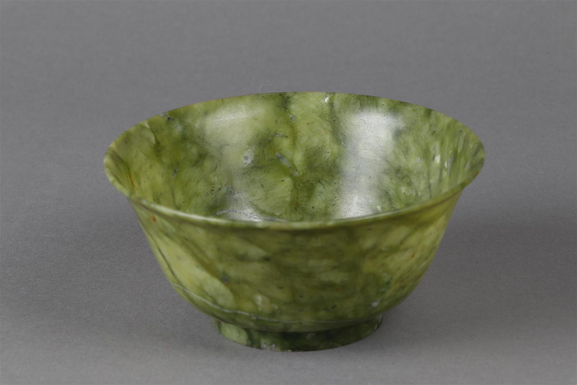 A Chinese thin-walled spinach green jade bowl. 20th century