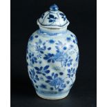 A porcelain twisted lid vase with floral decoration. China, Kangxi/Yongzheng.