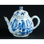 A ribbed porcelain teapot with floral decor. China, Kangxi. With silver spout mount, 19th century.