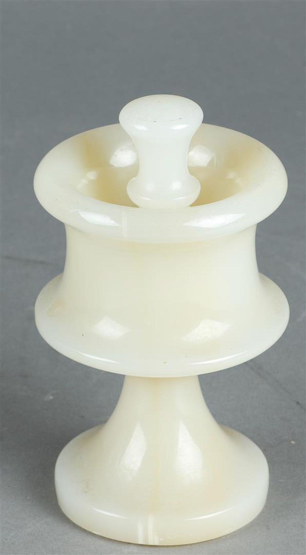 An alabaster mortar on foot with pestle. 19th century.