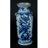 A porcelain angled vase with floral decor on rock. Marked with artemisia mark on the bottom. Missing