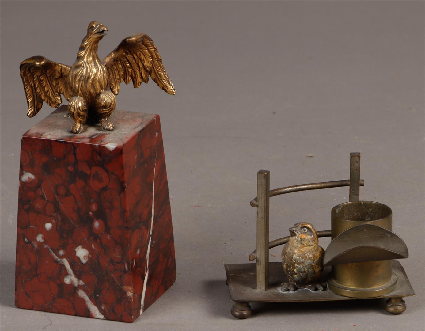 A lot consisting of  a desk ornament  with a seated eagle on a red marble base, and a pen holder and
