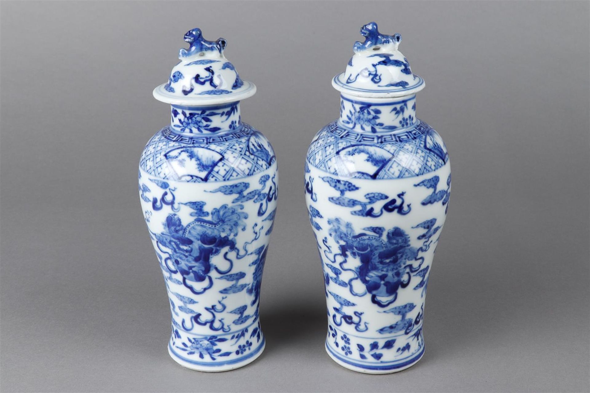 A set of two porcelain lidded vases decorated with dragons, marked Kangxi. China, 19th century.