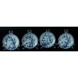 Four porcelain plates with rich floral decoration with two birds. China, Yongzheng.