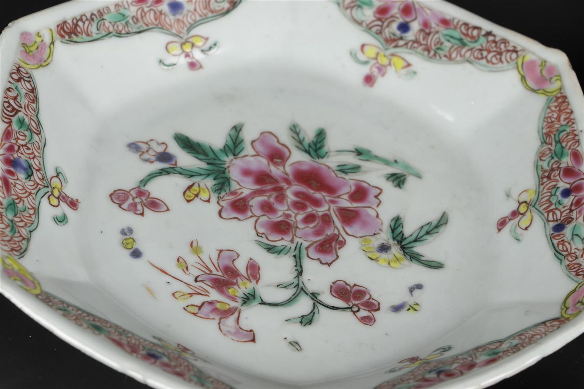 Three porcelain angled Famille Rose plates with rich floral decoration. China, Yongzheng/Qianlong. - Image 5 of 6