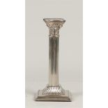 A silver-plated candlestick in the shape of a Corinthian column, marked "Made in England" (on the fo