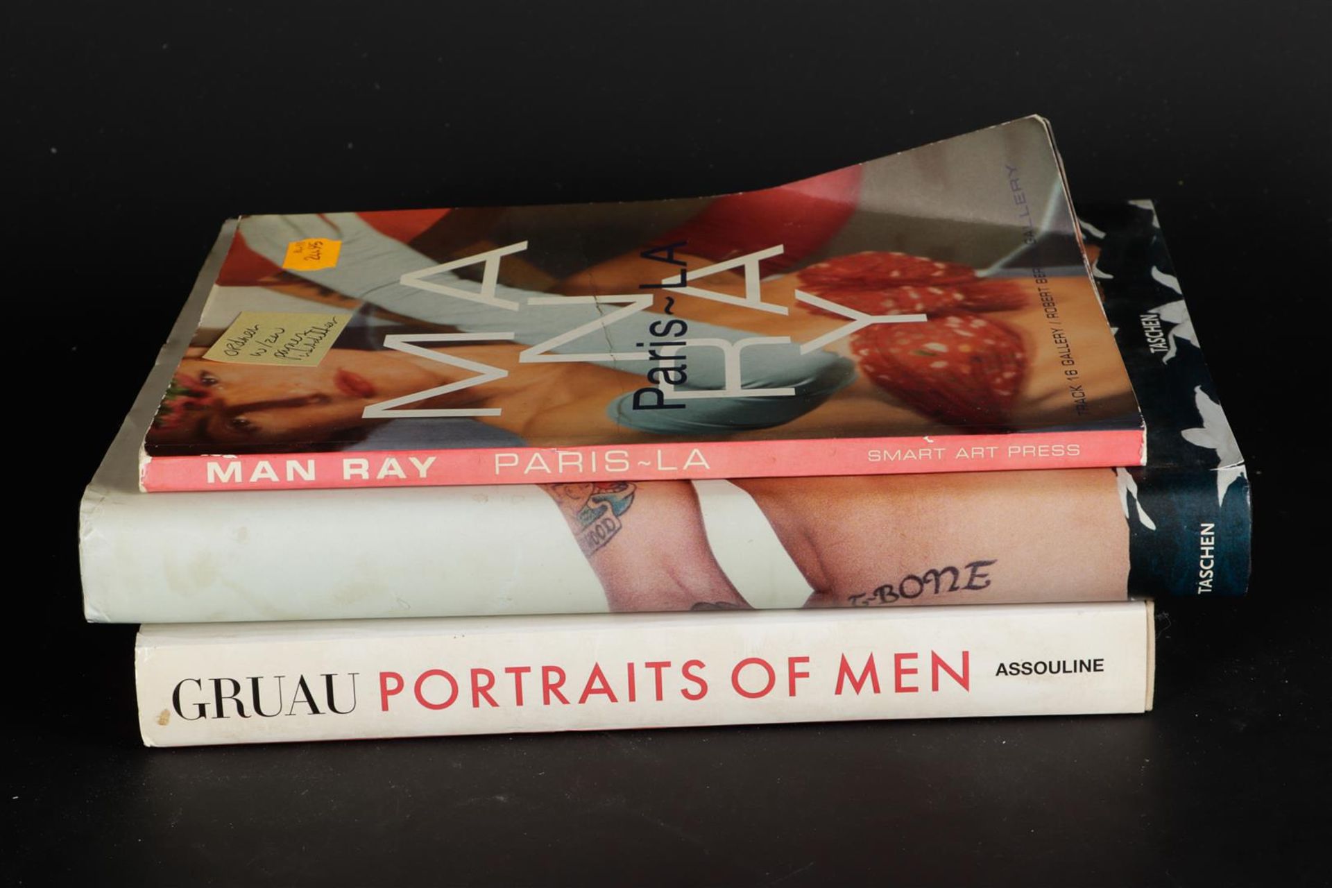 Collection of books including Gruau: Portraits of Men, Rejane Bargiel, 2012.