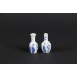 Two porcelain small model belly vases with long body decoration. China, Kangxi. Damage to neck.