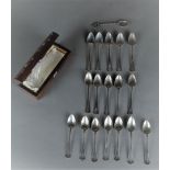 A wooden spoon box inlaid with silver thread and mother-of-pearl. In it 18, mostly silver, spoons. T