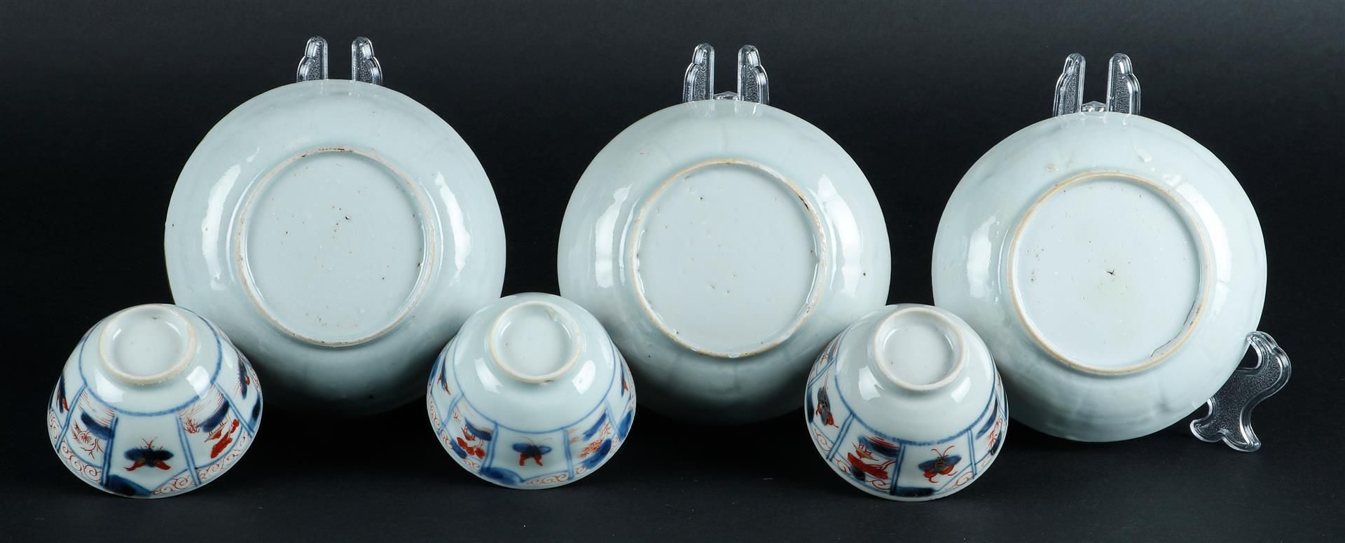 Three porcelain Imari cups and saucers with butterfly decor and floral decor, center with fisherman  - Image 4 of 4