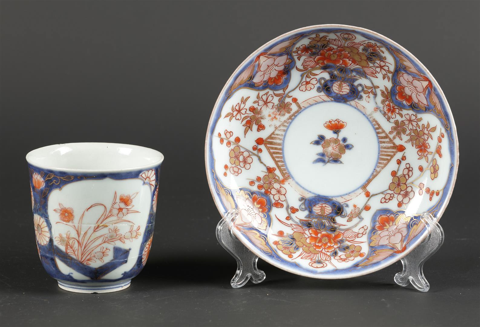 A porcelain Imari chocolate cup and saucer with floral decor in beds. Japan, 18th century