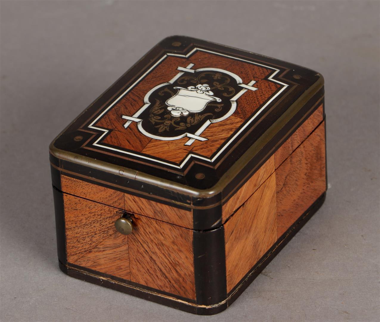 A 19th century box for storing a pocket watch. Inlaid with brass, bone and various types of wood. Fr