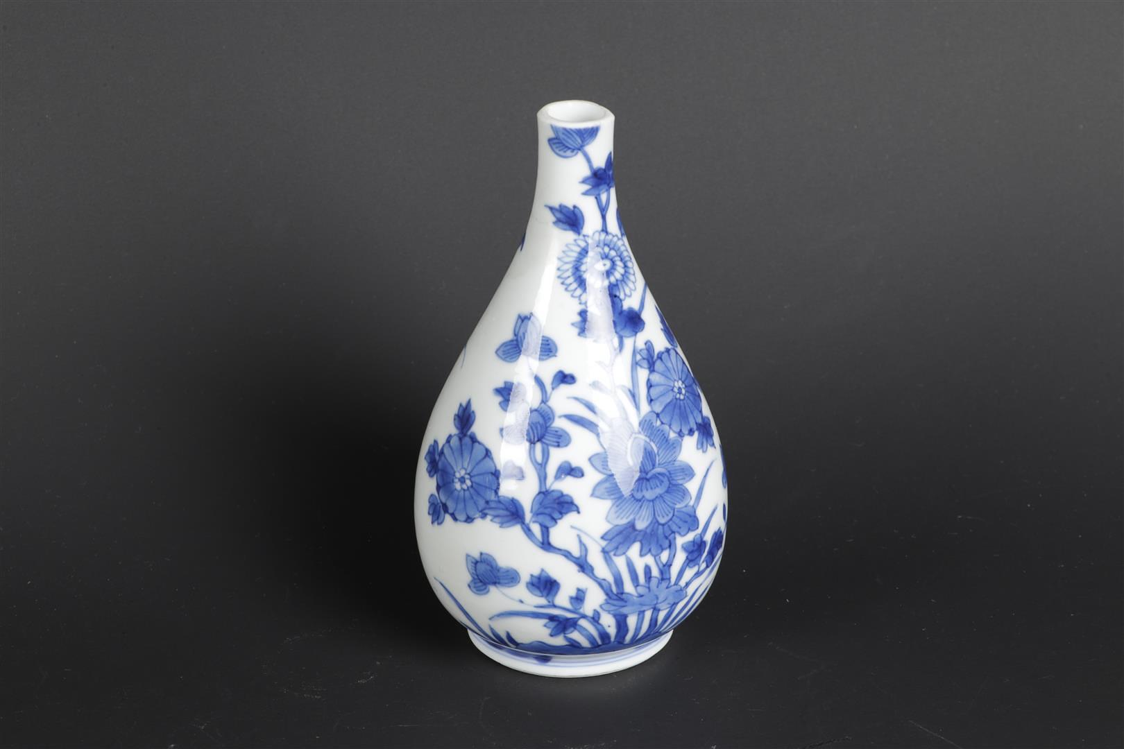 A porcelain belly vase with rich flower-on-rock decor on the front and back. China, Kangxi.