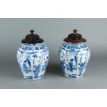 A pair of 18th century Delft vases with Kangxi decor in divisions. Both with wooden lid.