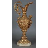 A large richly decorated bronze wine jug on a marble base. France, 19th century.