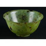 A Celadon Jade bowl with speckled decor. China, 19th/20th century.