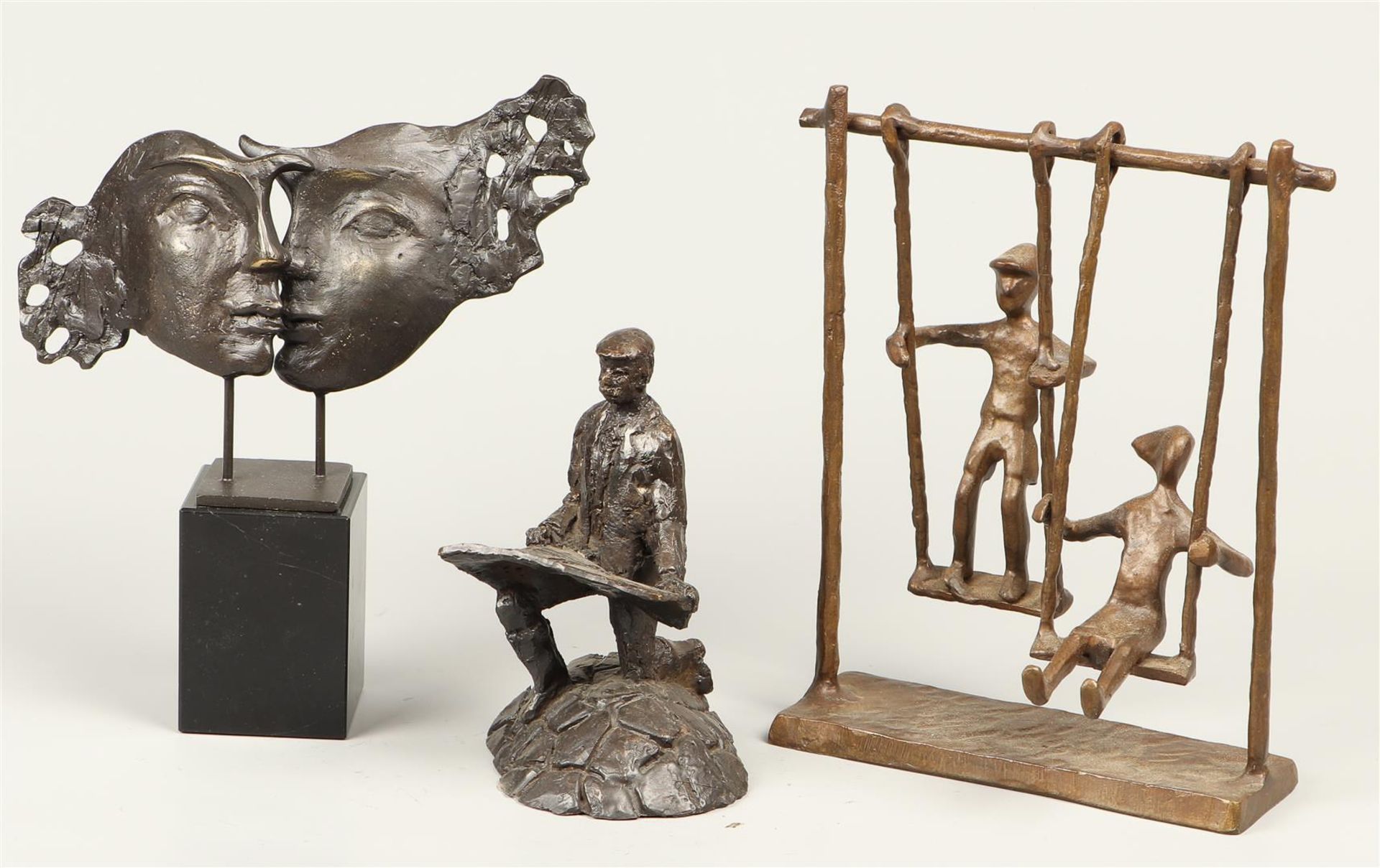 and three decorative bronze statuettes of rockers, two heads, and a dike warden.
