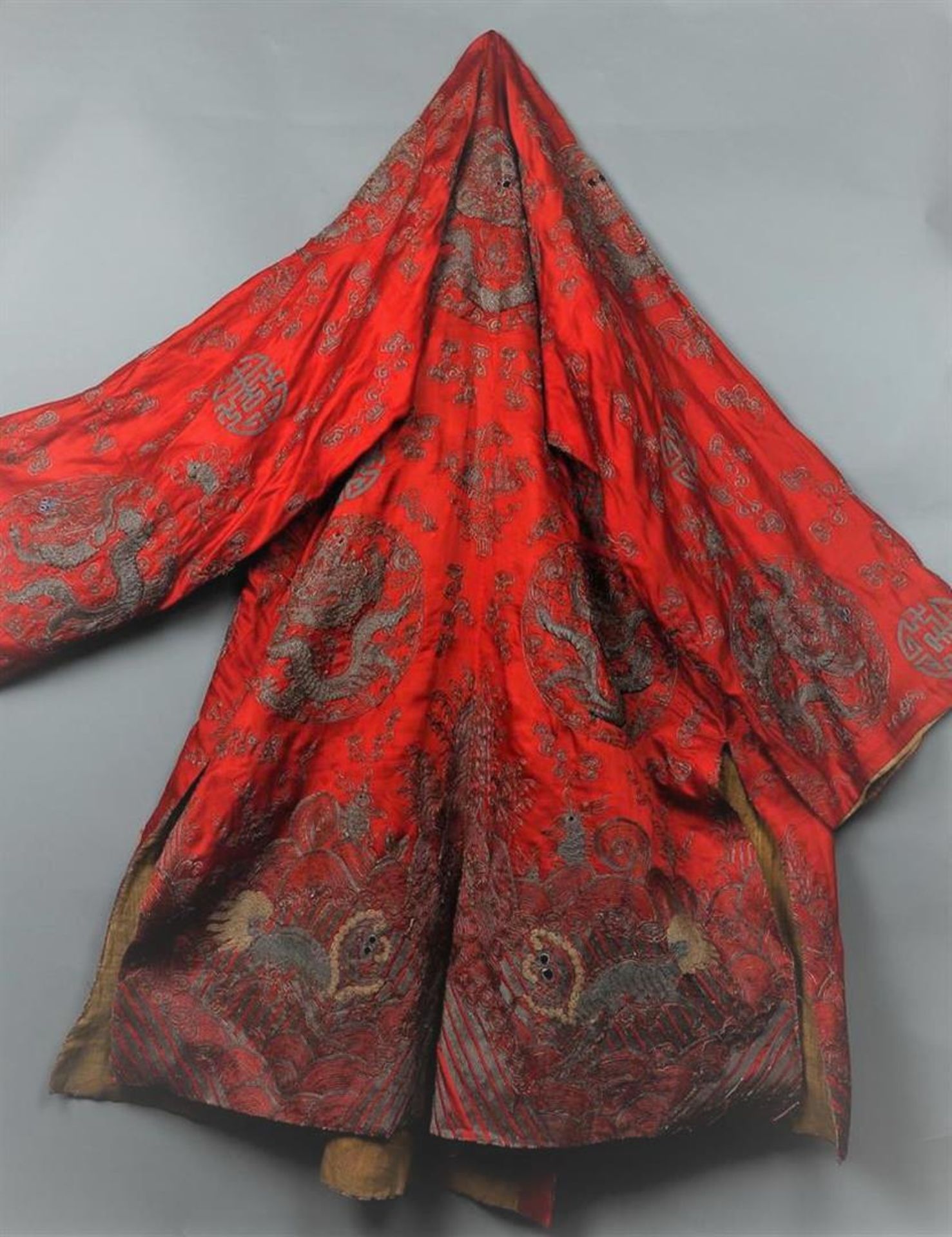 A 19th century embroidered silk cloak, decorated with dragons and Chinese characters.