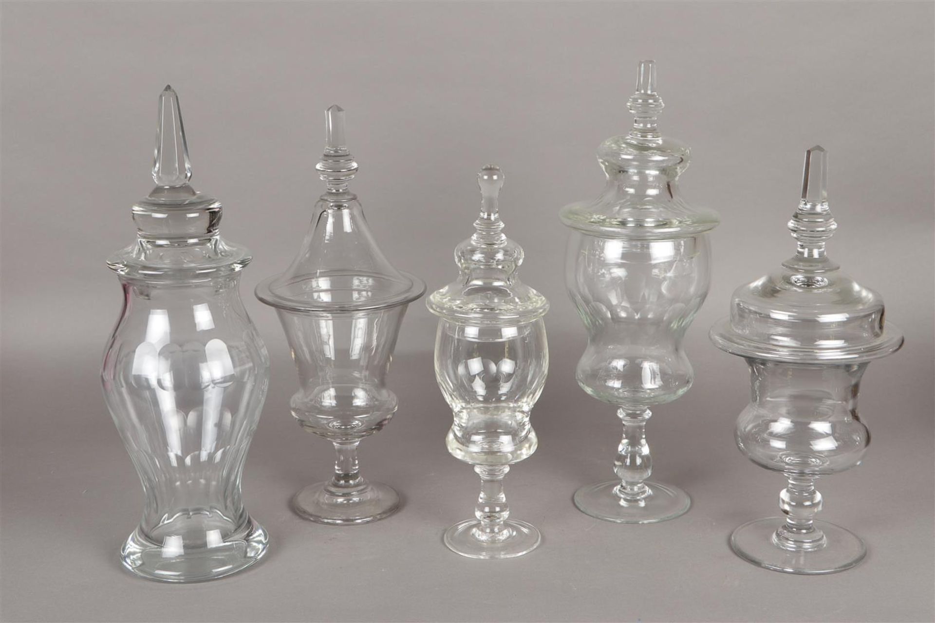 A lot of clear glass including various ginger coupes and vases.