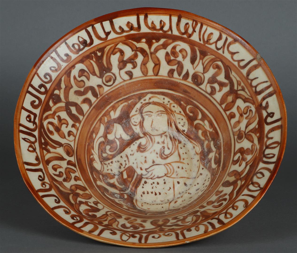 An earthenware nishapur bowl with floral decoration and decorated with a figure in the center. Persi - Image 2 of 3