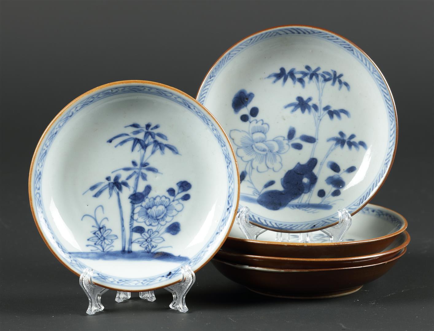 Five porcelain plates with peony and bamboo decor and capuchin exteriors. China, Qianlong.