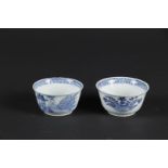 Two porcelain bowls with a pavilion between two columns on which a bird. China, Yongzheng.