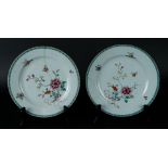 Two porcelain Famille Rose plates with floral decor with butterflies. China, Yongzheng.