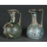 A lot consisting of (2) Roman oil/perfume bottles. 1st/2nd century AD.